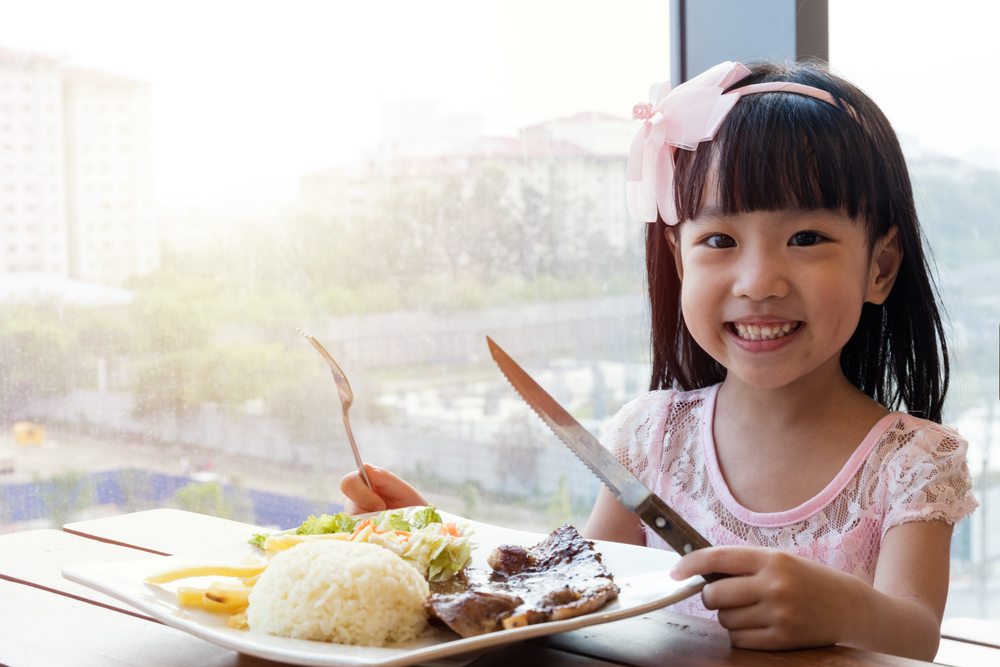 A girl in front of a plate of food
