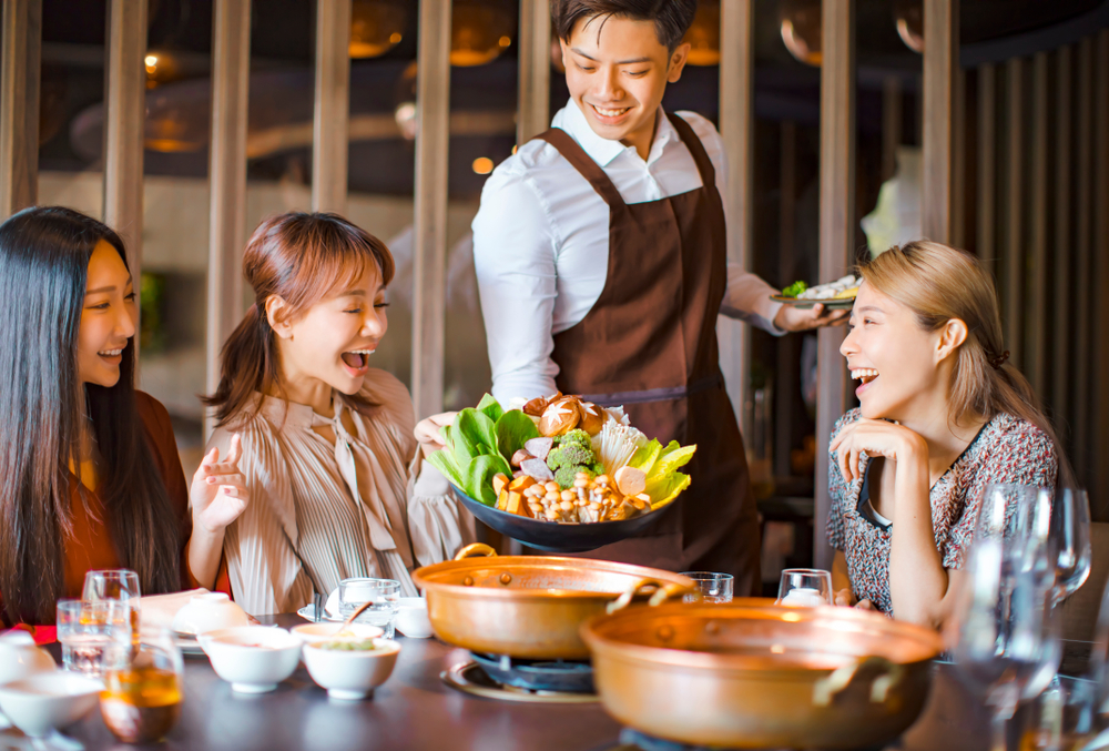 Friends enjoying food at a restaurant in Singapore