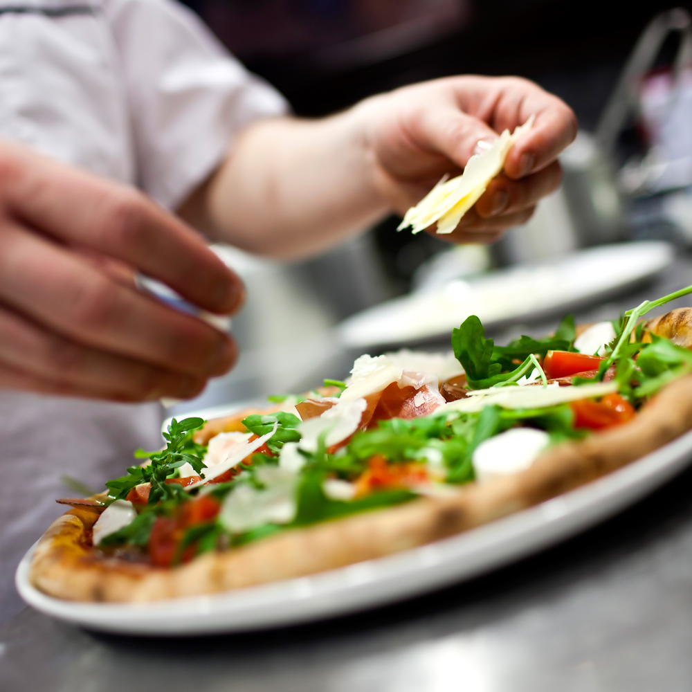 A chef preparing a pizza
