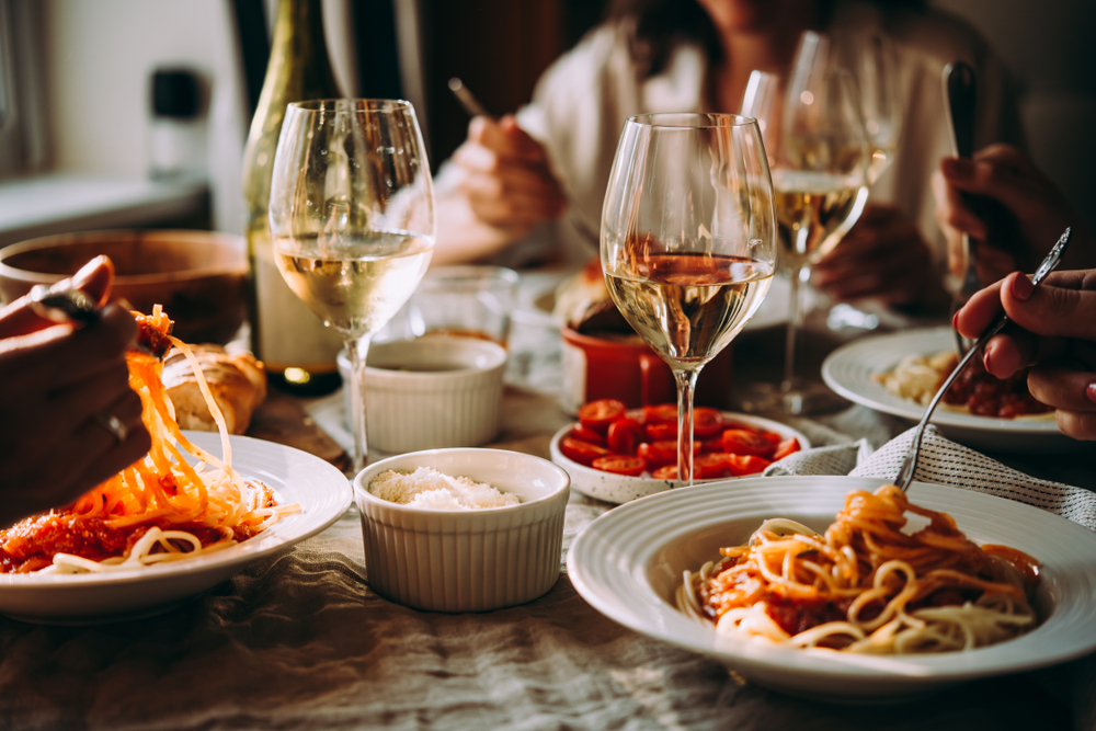 Diners enjoying wine and pasta